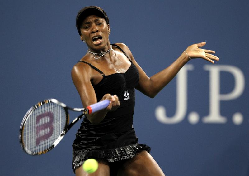 Venus Williams of the United States returns a forehand against Roberta Vinci of Italy during the Women's Singles first round match on day one of the 2010 U.S. Open.
